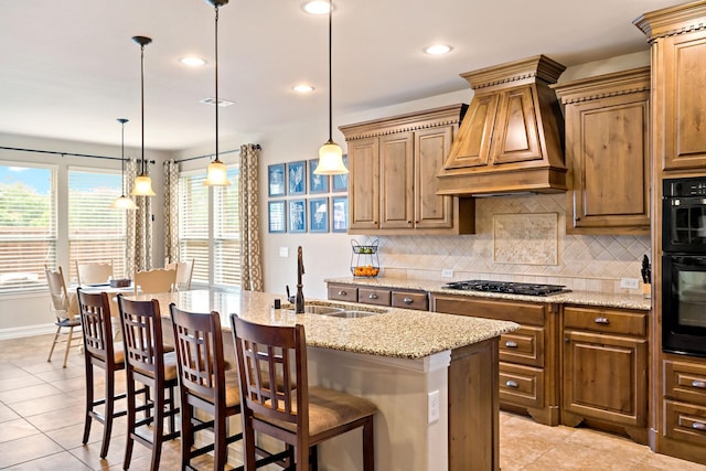 kitchen with light tile patterned flooring, a sink, custom range hood, gas stovetop, and backsplash