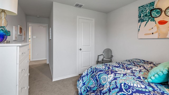bedroom with baseboards, light colored carpet, and visible vents