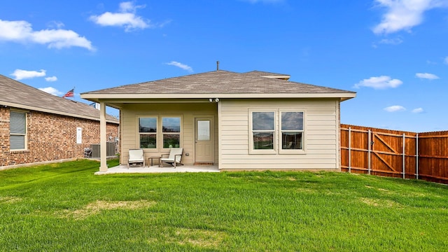 back of property with a patio, fence, and a yard