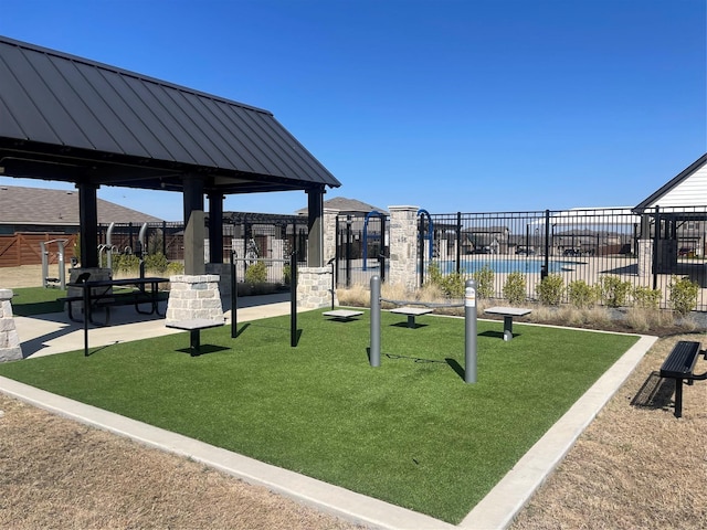 view of playground featuring fence, a gazebo, and a yard