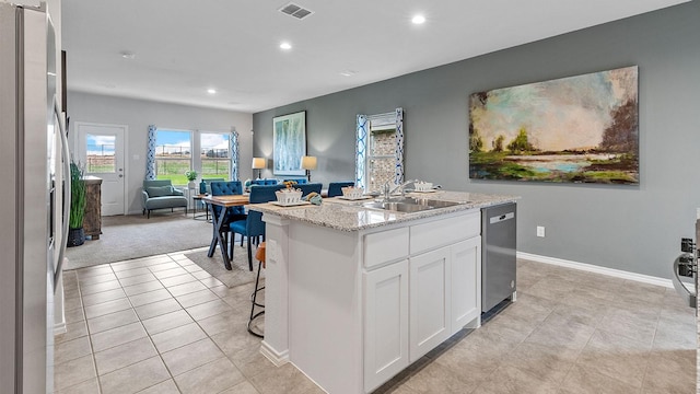 kitchen featuring visible vents, open floor plan, recessed lighting, a sink, and appliances with stainless steel finishes