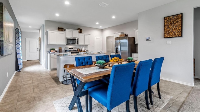 dining space with recessed lighting, baseboards, visible vents, and light tile patterned floors