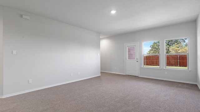 carpeted empty room with baseboards and recessed lighting