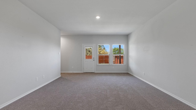 carpeted spare room with baseboards and recessed lighting