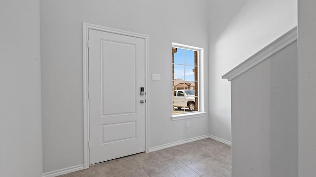 foyer entrance with baseboards and light tile patterned flooring