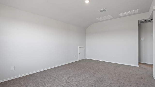 empty room featuring visible vents, baseboards, carpet floors, and lofted ceiling