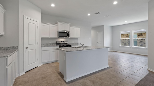 kitchen with stainless steel appliances, visible vents, white cabinetry, and light tile patterned floors