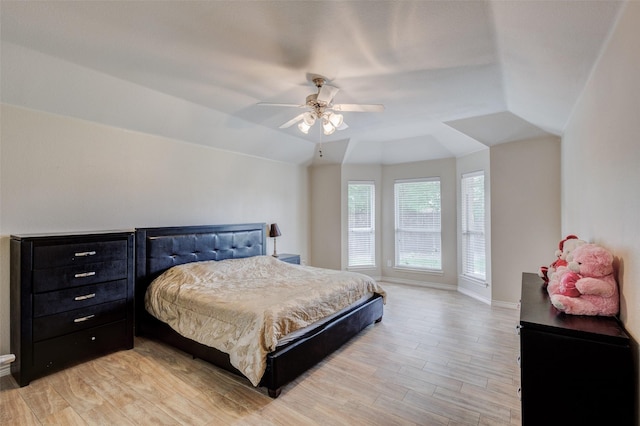 bedroom with light wood-style floors, baseboards, ceiling fan, and vaulted ceiling