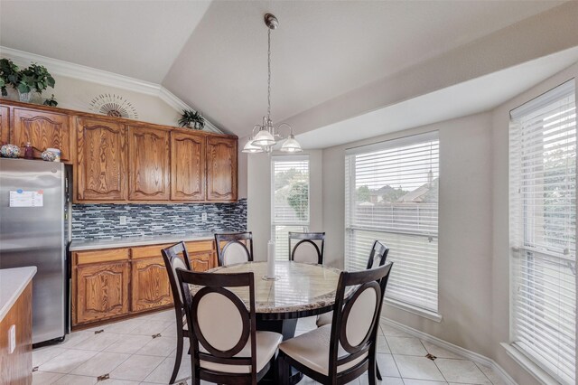 3002 Silver Springs Way, Rowlett, TX 75089 - dining area featuring light tile patterned flooring, lofted ceiling, and a chandelier