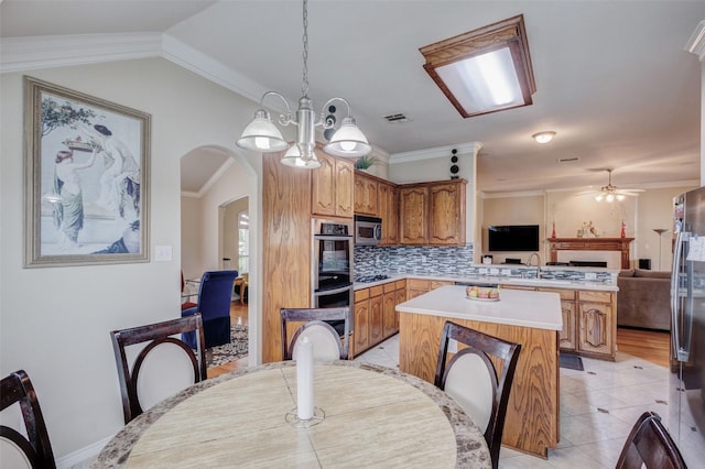 dining room featuring arched walkways, visible vents, light tile patterned floors, and ceiling fan with notable chandelier