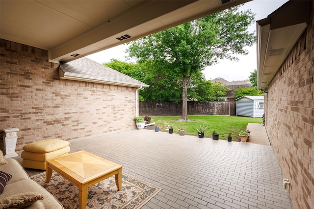 view of patio featuring an outdoor structure, a fenced backyard, and a storage shed