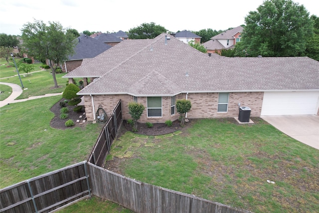 view of front facade featuring brick siding, a shingled roof, a fenced backyard, and a front lawn
