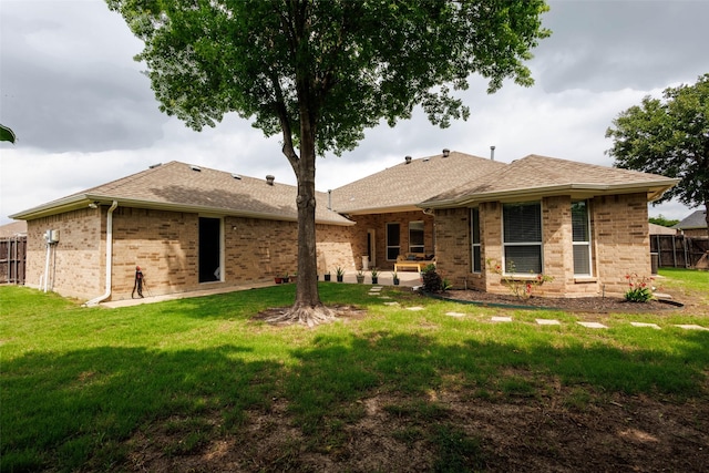 3002 Silver Springs Way, Rowlett, TX 75089 - back of house featuring brick siding, a shingled roof, and a patio