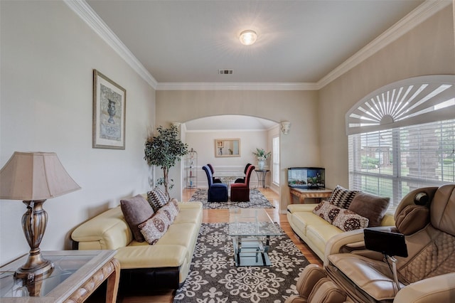 3002 Silver Springs Way, Rowlett, TX 75089 - living room featuring arched walkways, wood finished floors, and ornamental molding