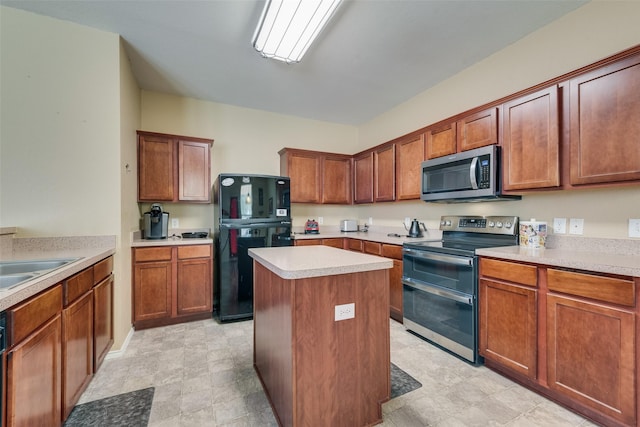 4312 Summer Star Ln, Fort Worth, TX 76244 - kitchen with light countertops, appliances with stainless steel finishes, brown cabinetry, and a kitchen island