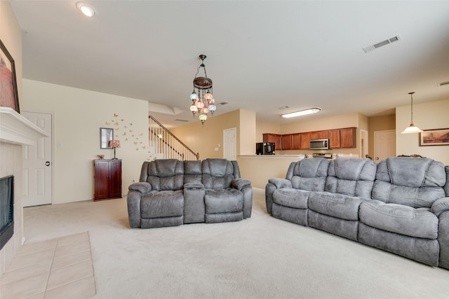 4312 Summer Star Ln, Fort Worth, TX 76244 - living area with visible vents, stairs, light colored carpet, a chandelier, and a tile fireplace