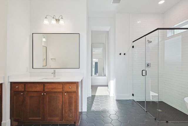 full bathroom featuring vanity, a shower stall, tile patterned floors, and visible vents