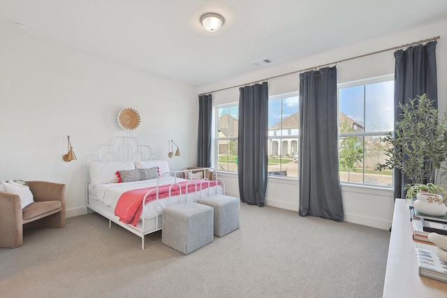 bedroom featuring visible vents, carpet flooring, and baseboards