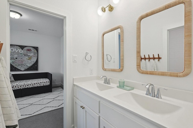 ensuite bathroom featuring a sink, ensuite bathroom, double vanity, and visible vents