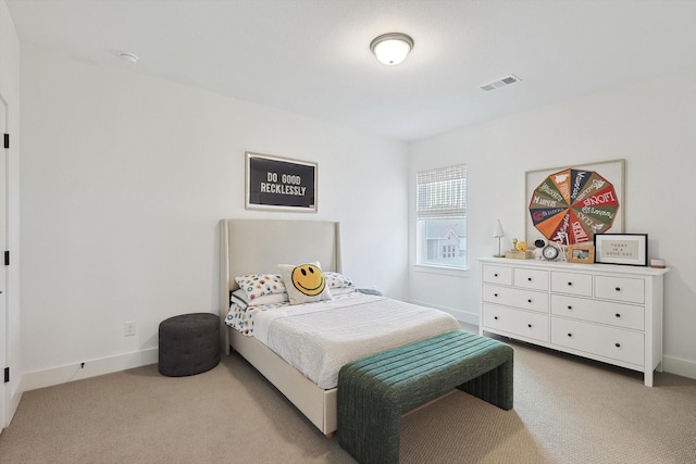 bedroom with baseboards, light carpet, and visible vents