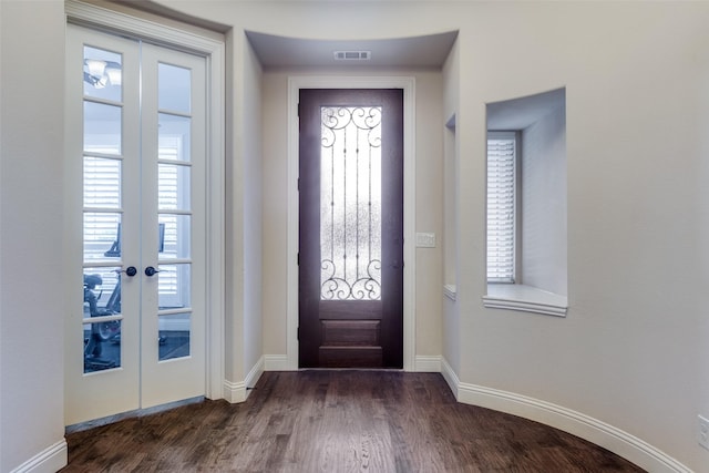 entrance foyer featuring visible vents, baseboards, dark wood-style floors, and french doors