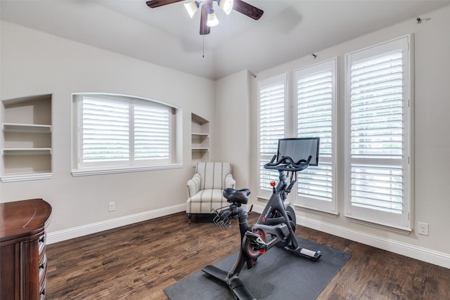 workout room with baseboards, a ceiling fan, and wood finished floors