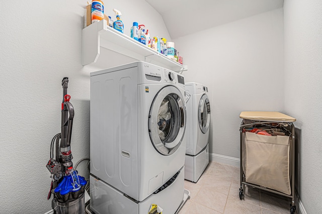 laundry area with independent washer and dryer, laundry area, baseboards, and light tile patterned floors