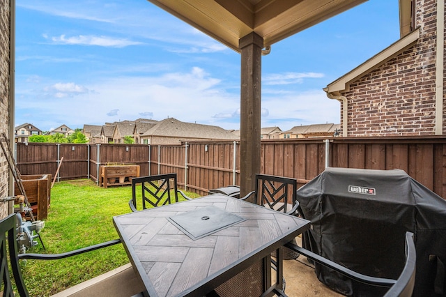 view of patio / terrace featuring a fenced backyard, outdoor dining space, area for grilling, and a residential view