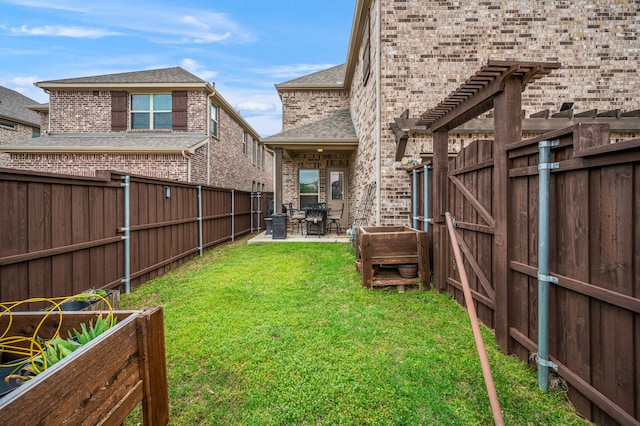 view of yard with a patio, a fenced backyard, and a gate
