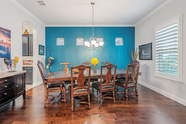 dining area with visible vents, crown molding, an accent wall, and a chandelier
