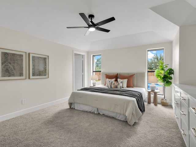 bedroom with baseboards, multiple windows, a ceiling fan, and light colored carpet