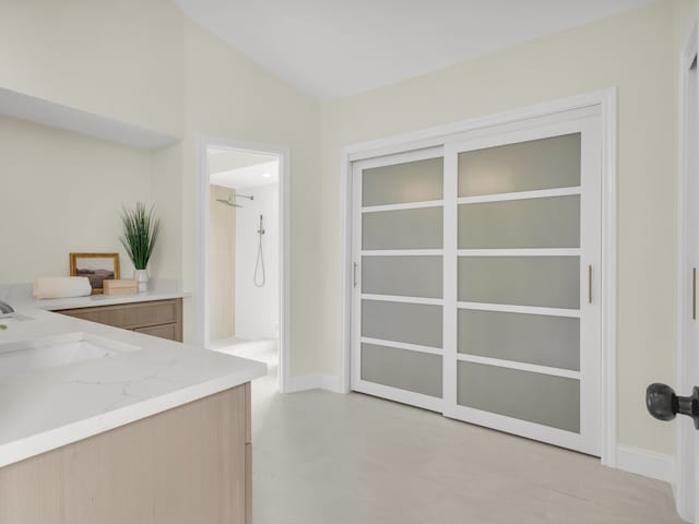 interior space featuring baseboards and a sink