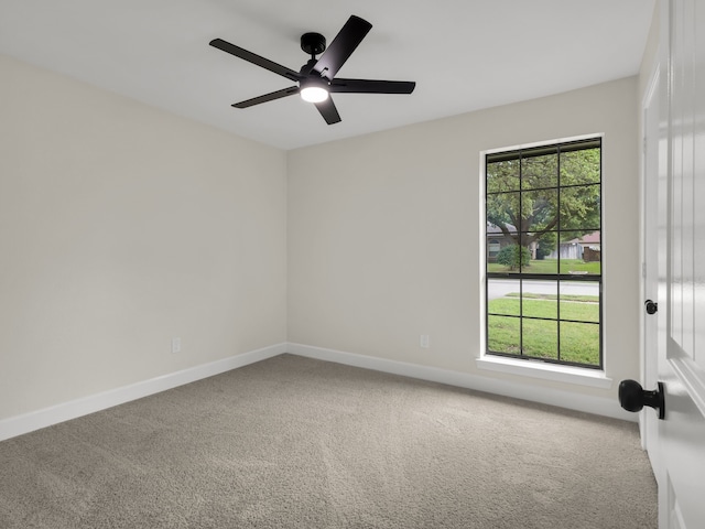 unfurnished room featuring carpet flooring, baseboards, and ceiling fan