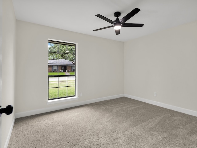 carpeted empty room with baseboards and ceiling fan