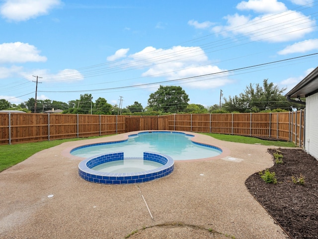 view of pool featuring a fenced backyard, a patio area, and a pool with connected hot tub