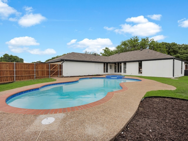 view of pool featuring fence, a pool with connected hot tub, and a patio area