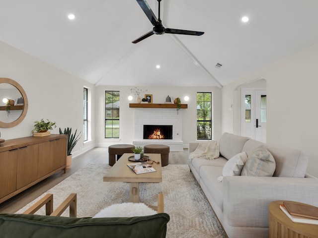 living room featuring a fireplace, recessed lighting, and visible vents