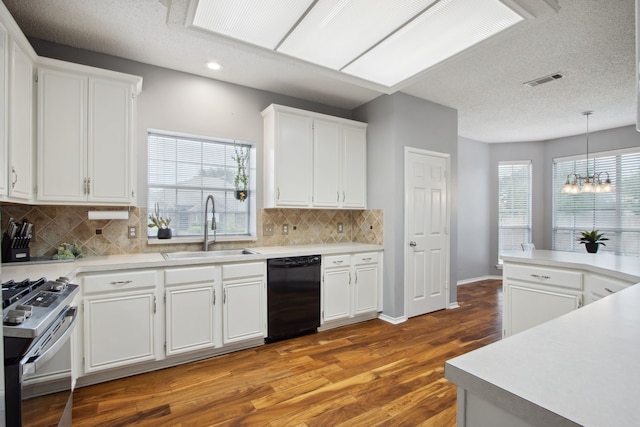 kitchen featuring a sink, dishwasher, stainless steel range with gas cooktop, wood finished floors, and visible vents