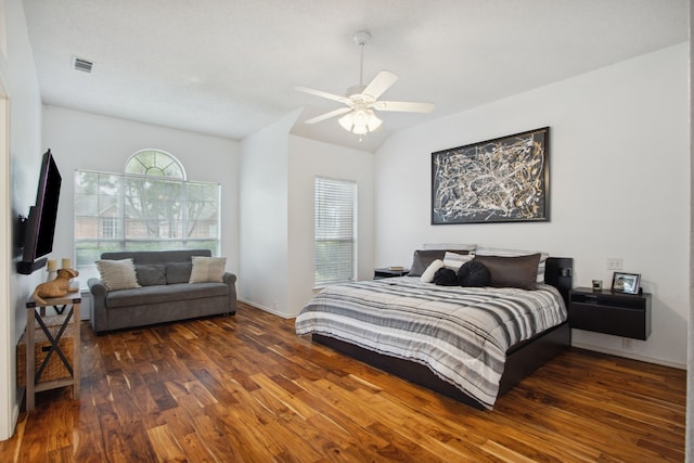 bedroom with visible vents, lofted ceiling, wood finished floors, and ceiling fan