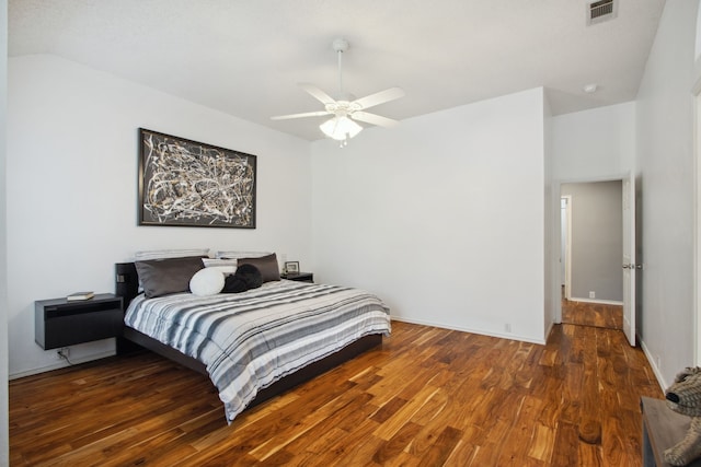 bedroom with visible vents, a ceiling fan, baseboards, and wood finished floors