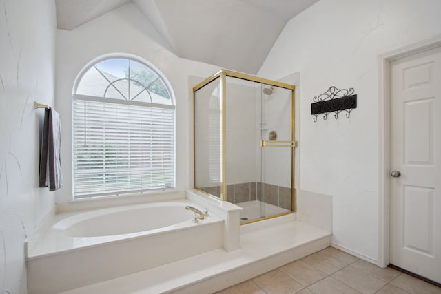 bathroom featuring a healthy amount of sunlight, vaulted ceiling, a stall shower, and a garden tub