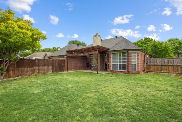 rear view of house with brick siding, a patio, a chimney, and a fenced backyard