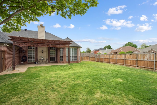 back of house featuring a lawn, brick siding, a fenced backyard, a patio, and a pergola