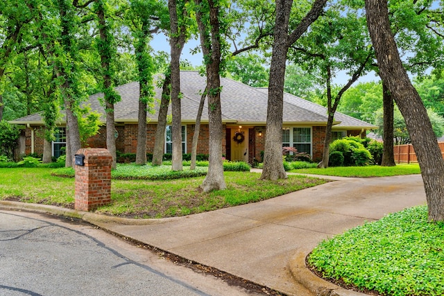 4705 El Salvador Ct, Arlington, TX 76017 - ranch-style home with brick siding, a shingled roof, fence, and a front yard
