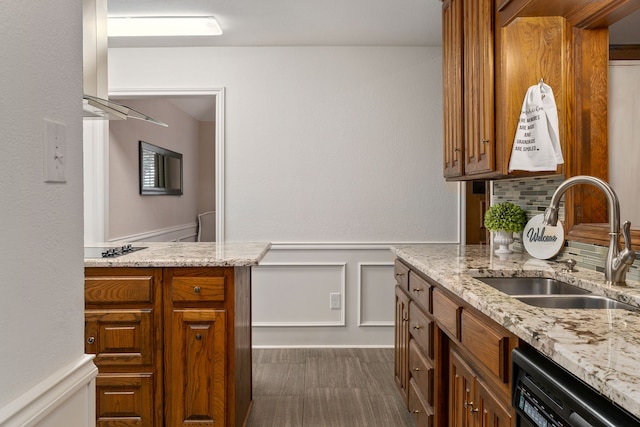 4705 El Salvador Ct, Arlington, TX 76017 - kitchen featuring a wainscoted wall, brown cabinets, light stone counters, a sink, and dishwasher
