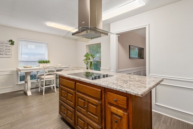 4705 El Salvador Ct, Arlington, TX 76017 - kitchen with a wainscoted wall, black electric cooktop, island range hood, and a decorative wall