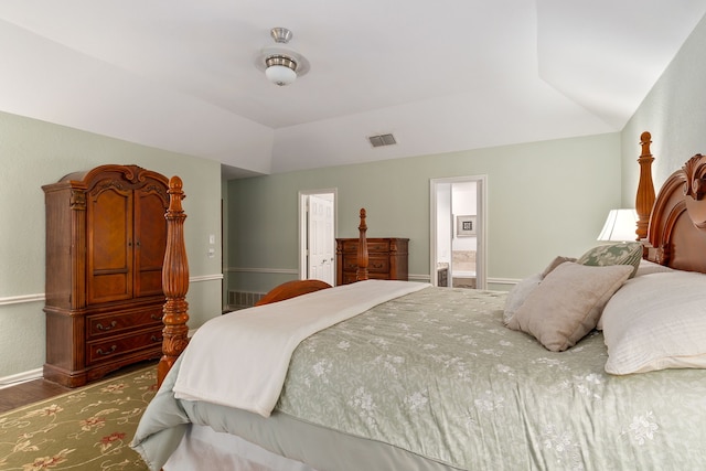 4705 El Salvador Ct, Arlington, TX 76017 - bedroom featuring visible vents, wood finished floors, vaulted ceiling, and ensuite bath