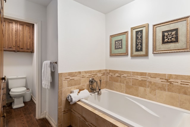 4705 El Salvador Ct, Arlington, TX 76017 - bathroom with toilet, a bath, and wood finished floors