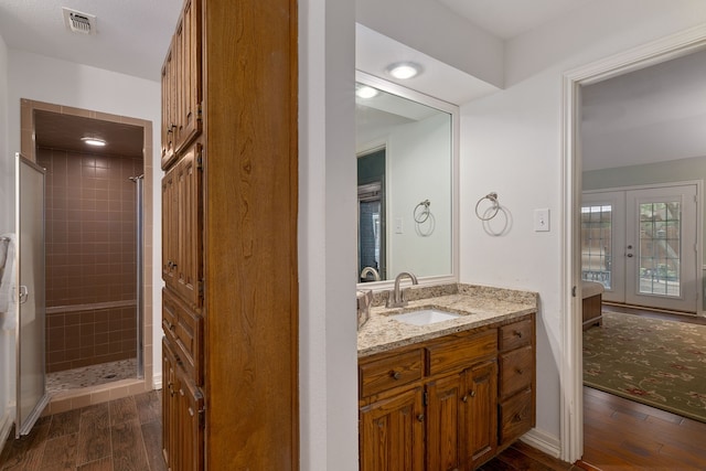 4705 El Salvador Ct, Arlington, TX 76017 - full bathroom with visible vents, wood finished floors, a tile shower, and french doors