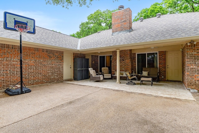 4705 El Salvador Ct, Arlington, TX 76017 - rear view of house featuring outdoor lounge area, a chimney, brick siding, a shingled roof, and a patio area